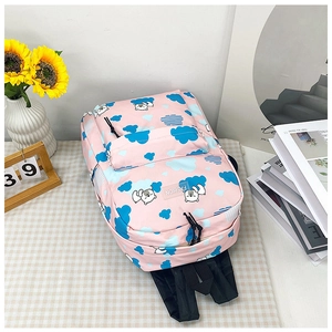 Vue détaillée du sac à dos rose à motif d'ours sur nappe à carreaux avec décor