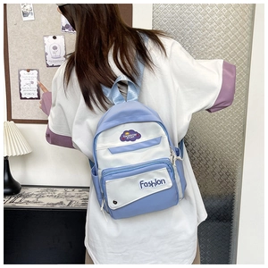 Detail of taro purple and beige contrast backpack with cloud patch and fashion label
