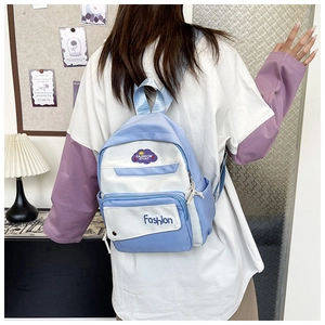 Detail of blue and white nylon backpack featuring fashion sport cloud patch and pockets
