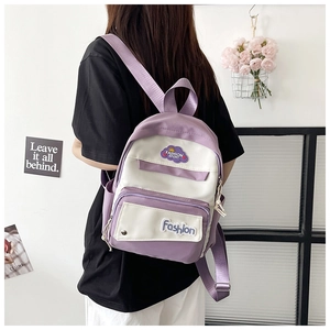 Close-up of lavender and white contrast backpack featuring fashion sport patches and wide straps