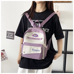 Detail of color-block mini backpack with purple and white fabric and cloud logo patch