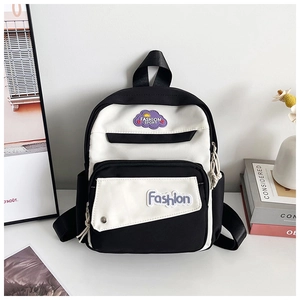 Detail view of mini monochrome backpack with cloud patch and white contrast pockets