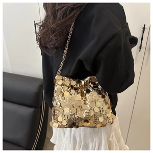 Detailed view of the sparkling gold sequin bucket bag with elegant metal chain strap