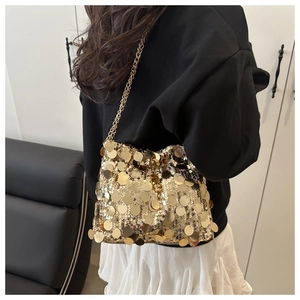Close-up of sparkling gold sequin crossbody bag with elegant metal chain strap