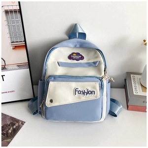 Close-up of light blue and beige school backpack featuring front zipper pockets and logo