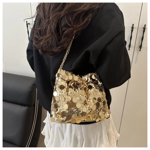 Detail of gold large sequin chain bag showing shimmering texture and metallic strap