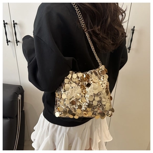 Detailed macro view of the gold sequin handbag with metallic chain shoulder strap