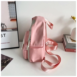Side view detail of pink and white casual backpack with zipper pocket and side water bottle slot