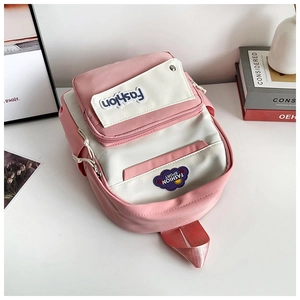 Detail of pink and white contrast backpack with Fashion embroidery and sport badge