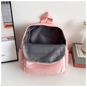 Spacious main compartment of the pink and white color-block backpack with grey lining