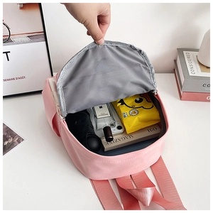 Pink minimalist backpack interior showing spacious storage for books and accessories