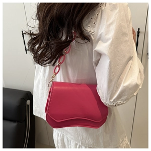 Hot pink PU leather shoulder bag with unique wavy flap and chunky acrylic chain detail
