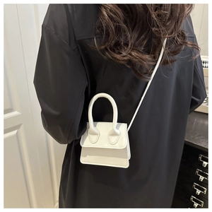 Mini white crossbody bag detail showing compact size and sleek minimalist pu leather finish