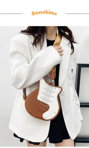 Detail view of guitar-shaped crossbody bag with contrast stitching and wide strap
