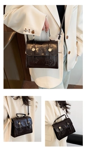Detail showing vintage small square bag texture with star embossed flap and adjustable strap