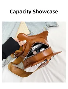 Interior capacity of the brown cat-eared crossbody bag showing phone and daily items