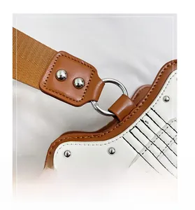 Detailed close-up of guitar-shaped handbag with silver rivets and durable D-ring connector