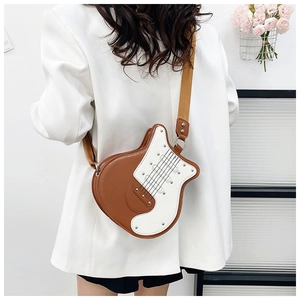 Detailed view of guitar-shaped crossbody bag with brown PU leather and rivet accents