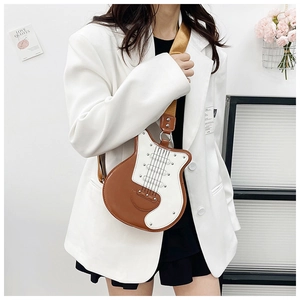 Close-up of guitar-shaped crossbody bag featuring metal rivets and bicolor PU leather