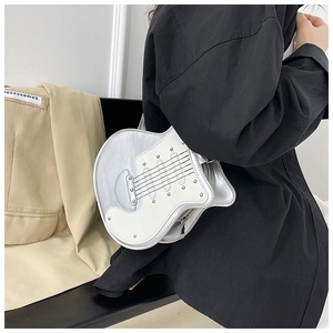 Detail view of guitar shaped silver shoulder bag with metallic studs and zip closure