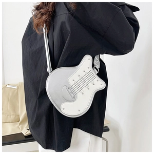 Creative guitar-shaped crossbody bag featuring silver and white leather with metal studs