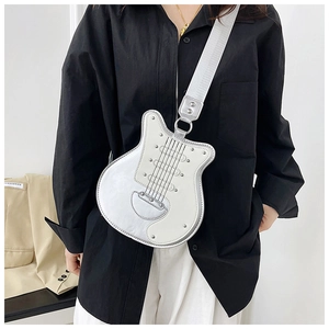 Macro view of guitar-shaped crossbody bag with rivet details and silver metallic finish