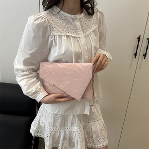 Pochette enveloppe rose pâle en cuir plissé avec boucle dorée et dragonne amovible