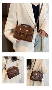 Detail view of brown vintage oil wax leather mini square handbag with fashion gold lettering