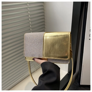 Detail of elegant gold metallic and glitter panel stitching on a square crossbody bag