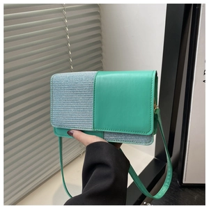 Detail of green and blue glitter patchwork on a stylish PU leather crossbody bag