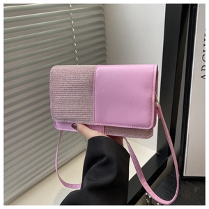 Detail of pink leather handbag featuring a sequined flap and adjustable shoulder strap