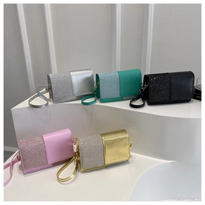 Detail of glitter patchwork crossbody square bags in five colors on minimalist pedestals