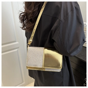 Side view of a woman wearing a shiny gold and silver sequin patchwork crossbody bag