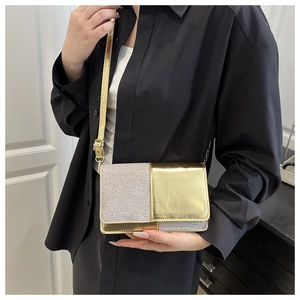 Detail of crossbody bag featuring silver rhinestone patchwork and gold metallic finish
