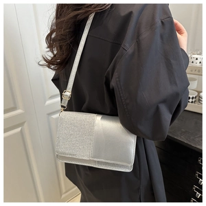Detail of silver crossbody bag with glitter fabric and matte leather contrast texture