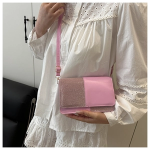 Detail of pink leather crossbody bag with sequin patchwork and gold metal buckle
