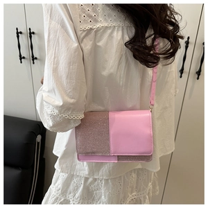 Detail of pink crossbody bag featuring a sequined and smooth leather patchwork design