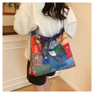 Detail of bohemian patchwork tote bag with colorful geometric patterns and ribbon tie