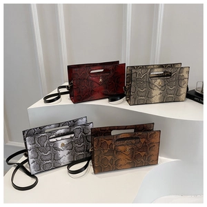Detailed view of four snakeskin print envelope bags in red, beige, black, and brown colors