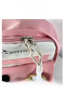 Detail view of smooth metal two-way zippers with woven cord pulls on a school backpack