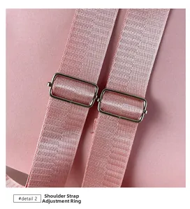 Macro shot of adjustable pink woven shoulder strap with metal buckle hardware