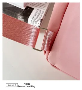 Close-up of pink nylon backpack featuring high-quality silver square hardware and texture