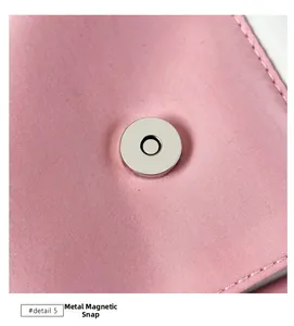 Close-up of the silver magnetic snap closure on a pink fabric school backpack