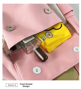Detailed view of the front pocket on a pink nylon bag showing magnetic buckle and storage