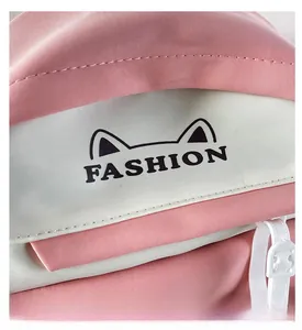 Detail of pink and white backpack featuring FASHION embroidery and high-quality stitching