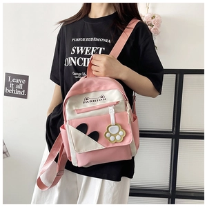 Pink and white backpack with cat ear design shown on a model for casual daily use