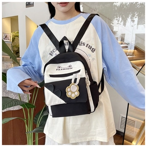 Detail of cute cat-ear mini backpack with fashion lettering and paw charm