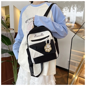 Detail of black and white canvas mini backpack with cute cat ears and fashion text