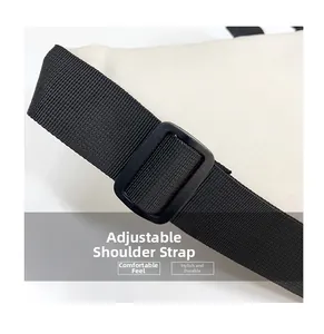 Detail view of adjustable black woven shoulder strap with plastic buckle for white bag