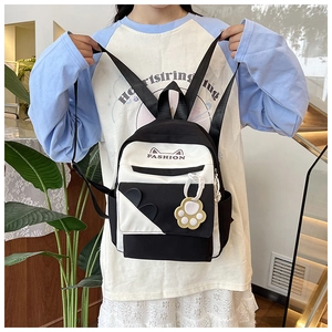 Detail of cute cat-ear canvas backpack featuring fashion text and cat paw charm